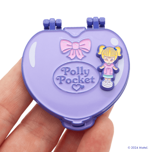 Purple Heart Compact Hinge Pin. This tiny Polly magnet can stick anywhere – inside the compact in her playhouse or outside on the landscape, and even on your refrigerator!