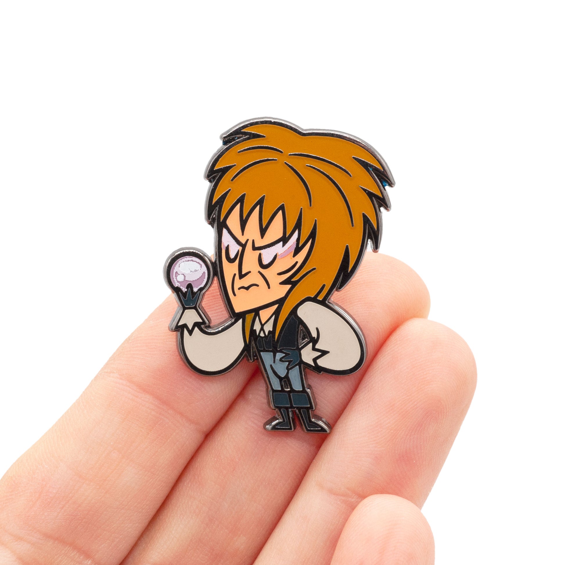 the goblin king lapel pin being held by hand to show scale.
