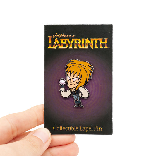 the goblin king pin on purple labyrinth backing card, being held by hand.