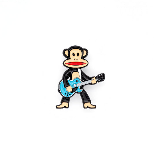 Julius the monkey is standing tall and rocking with his turquoise colored guitar! Julius has his mouth open, showing red, and is shot against a white background.