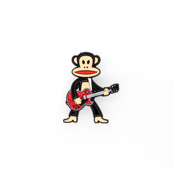 Julius the monkey is standing tall and rocking with his red glitter colored guitar! Julius has his mouth open, showing red, and is shot against a white background.