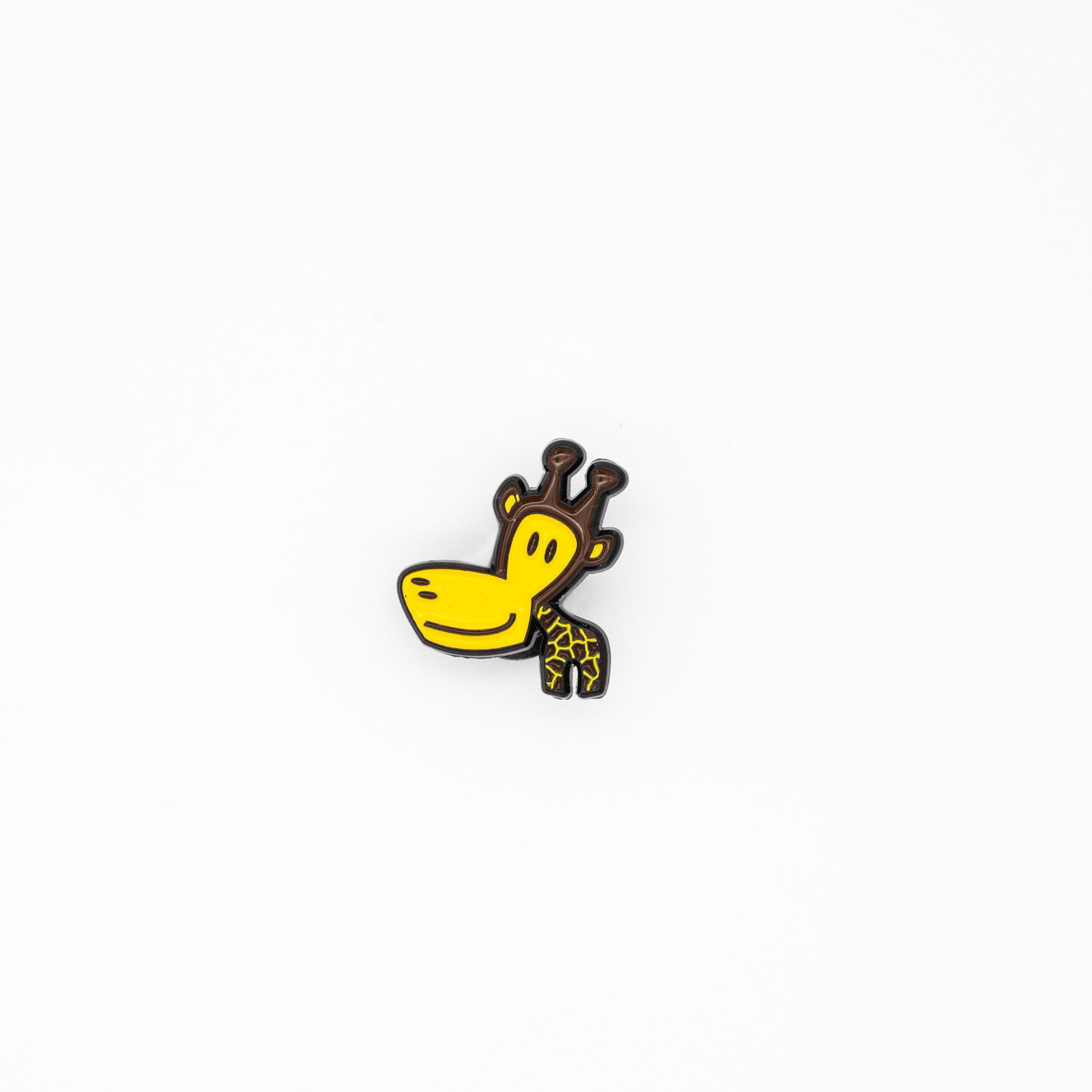 small brown and yellow giraffe pin on white background