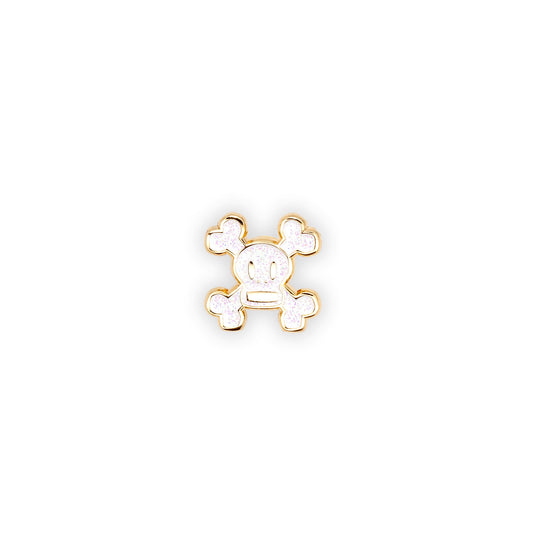 Skurvy limited edition pin is gold plated soft enamel with white glitter fill.  shot on a white background.