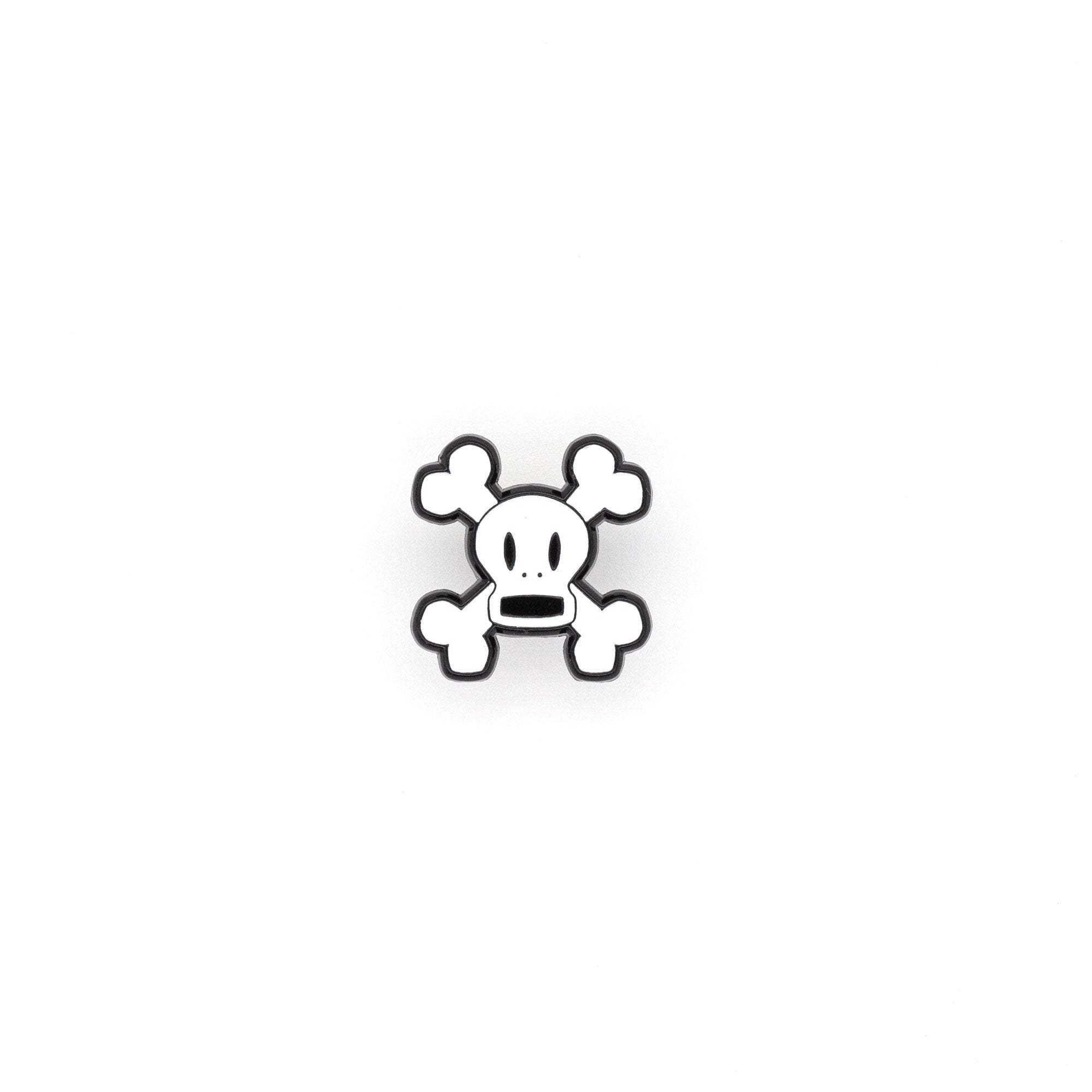 Skurvy is a soft enamel pin of white crossbones with an open mouth. shot on a white background